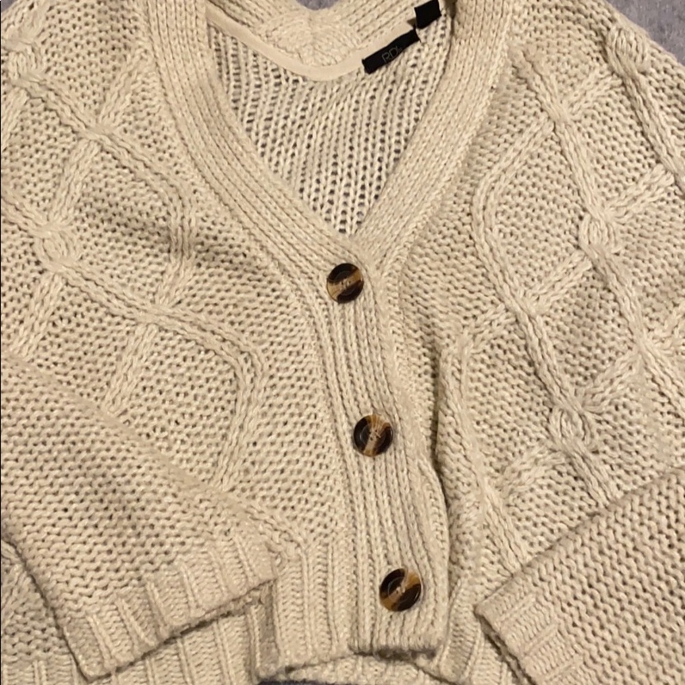 Knitted sweater with large buttons
